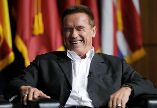 Former California Governor Schwarzenegger reacts during USC's Schwarzenegger Institute for State and Global Policy inaugural Symposium in Los Angeles
