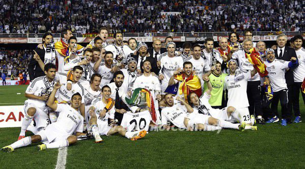 Real Madrid players celebrate with the trophy after winning the King's Cup final soccer match against Barcelona in Valencia