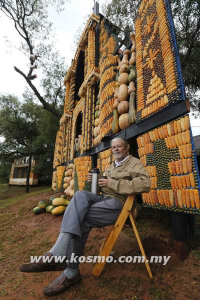 Paraguayan artist Koki Ruiz poses in front of an altar he built for the first time with corn, pumpkin and coconut, a day before the "Via Crucis" (Way of the Cross) in Tanarandy, San Ignacio, in the province of Misiones