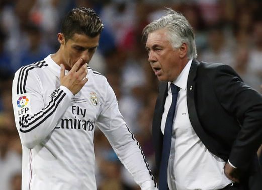 Real Madrid's Ronaldo receives instructions from his coach Carlo Ancelotti during their Spanish Super Cup first leg soccer match against Atletico Madrid in Madrid